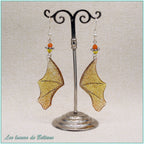 Boucles d'oreilles ailes de dragon en résine orange pailletée, faites main